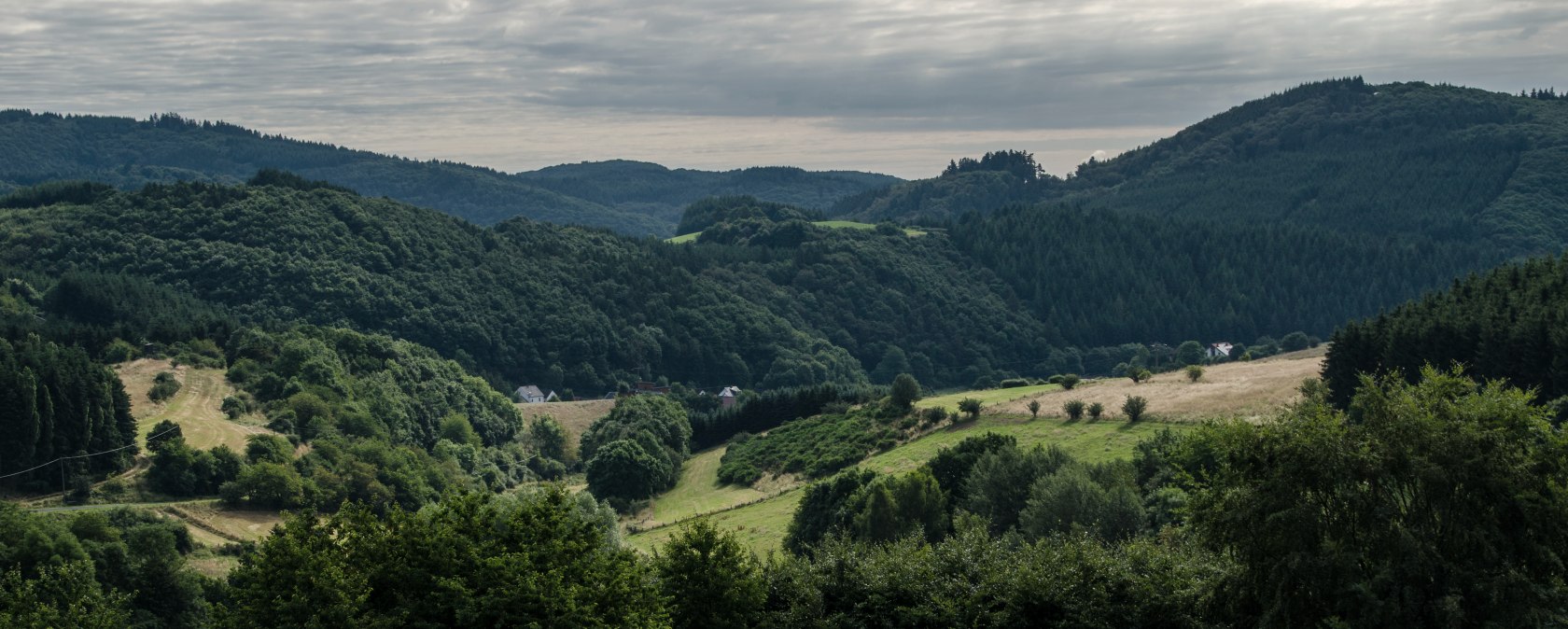 Green hills and forests under a cloudy sky, typical of a picturesque hiking landscape., © Volker Windheuser Green hills and forests under a cloudy sky, typical of a picturesque hiking landscape., © Volker Windheuser
