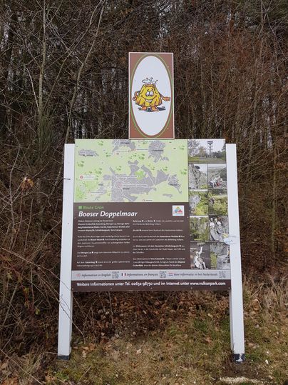An information sign about the Booser Doppelmoor. It displays a map and provides details on the hiking trails in the area.