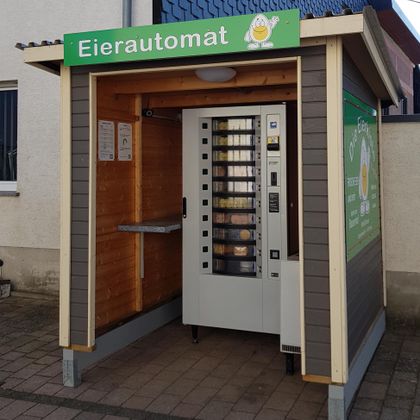 An egg vending machine in a wooden house. The machine is designed for the order of fresh eggs.