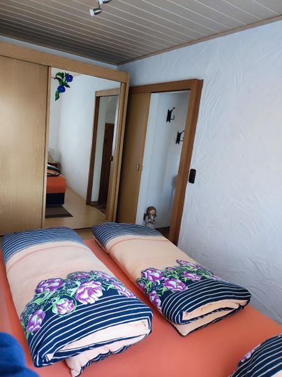 Schlafzimmer mit einem Queensize-Bett, (bei bedarf zwei Beistellbetten) und großem Kleiderschrank.